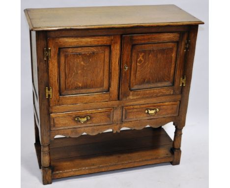 A reproduction joined oak side cabinet,with 2 panelled doors, drawers under and shelf below with turned legs, width 3'2", hei