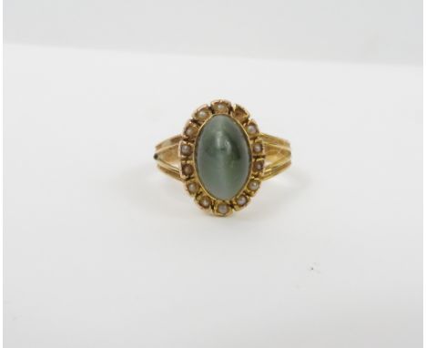 A chrysoberyl cats eye and seed pearl cluster ring, circa 1900, unmarked gold, finger size L, 1.5 g gross, with box