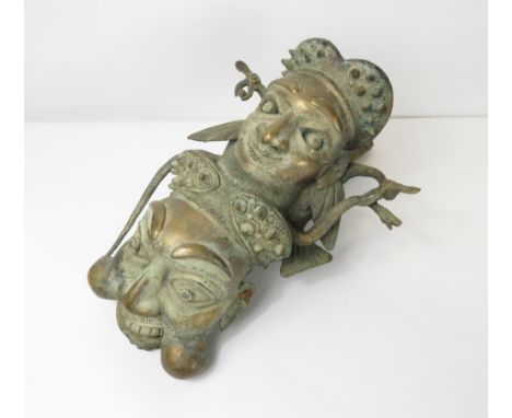 An interesting brass Cameroonian smoking pipe, the front decorated with two face masks, 27cm high