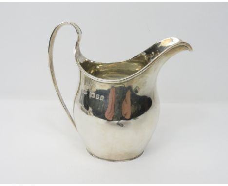 A silver helmet shaped cream jug, by Padgett &amp; Braham, London 1930, of plain Georgian style, 11 cm high, 121g (3.9 troy o