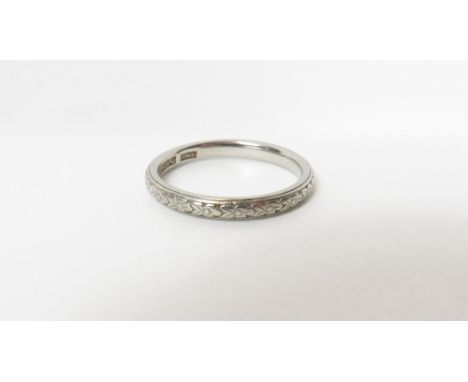 A patterned wedding ring, the white metal stamped 'Platinum', finger size J1/2, 3.1 g gross, cased