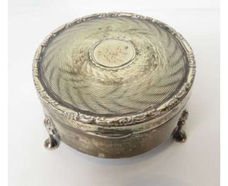 A circular silver trinket box, by Colen Hewer Cheshire, Chester 1913, the cover with engine turned decoration and vacant cart