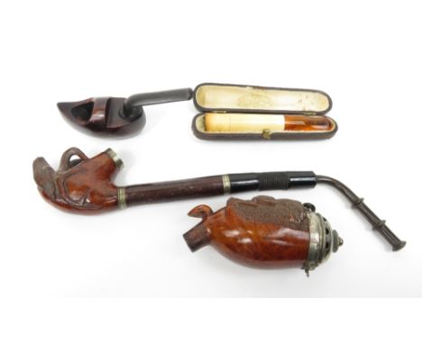 A cased cheroot holder, along with a Dutch pipe in the form of a clog and two other pipes