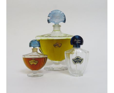 A vintage Guerlain, Paris 'Shalimar' Baccarat shop fatice bottle with blue glass stopper and applied gold tone label; unseale