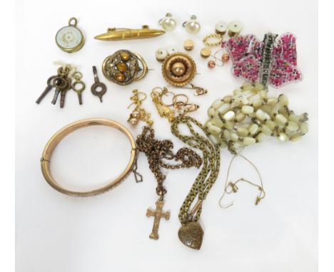 A collection of jewellery, including; brooches; a metal hinged bangle; a mother of pearl Rosary; and other items