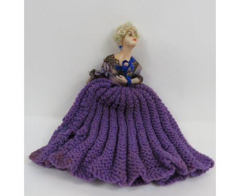 A 20th century wax doll with ceramic arms and a silk blue top, 10cm long