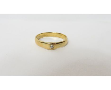 A diamond set wedding ring, unmarked, the diamond of approximately 0.03 carats, finger size Q, 3.8 g gross