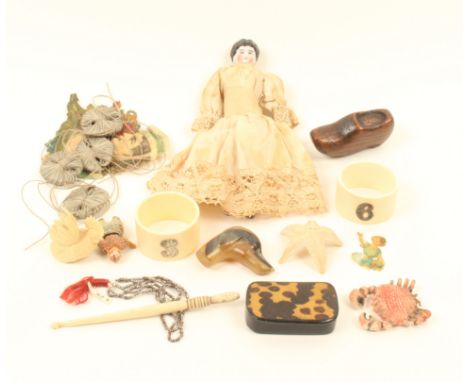 A mixed lot, comprising; a ceramic head doll, 16cm, a miniature doll, a horn dog's head whip handle, papier-m«chª snuff box, 