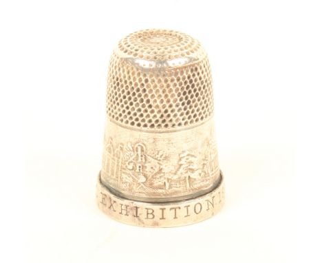 A rare silver thimble, the frieze depicting The international Exhibition, the rim impressed 'International Exhibition 1862'. 