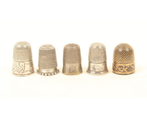 Five children's thimbles, comprising; an 18th century part gilded example, the border with leaf scrolls and motifs, including