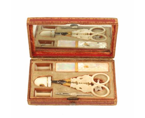 A Palais Royal sewing set, the rectangular red leather case with gilt tooled borders, the lid interior with mirror over a sil