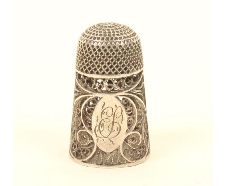 A late 18th century English silver filigree thimble, with deep quill work border set with an oval cartouche with engraved ini