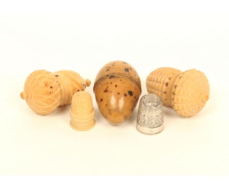 Three vegetable ivory thimble cases, comprising; an acorn form example with hatched and spiral decoration, complete with vege