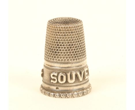 A French silver thimble, with raised letter border 'Souvenir' over a fancy rim.