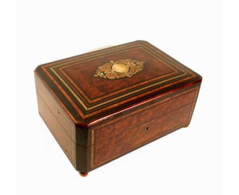 A French amboyna and inlaid musical sewing box, circa 1870, of rectangular form with canted corners, the cushion form lid wit