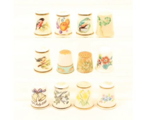Eight Royal Worcester thimbles and four other ceramic thimbles, six Worcester examples with black mark, three of birds, three