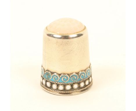 A Norwegian silver thimble, with enamelled 'waves and dot' border, below a moonstone top, marked to the internal apex '925' a