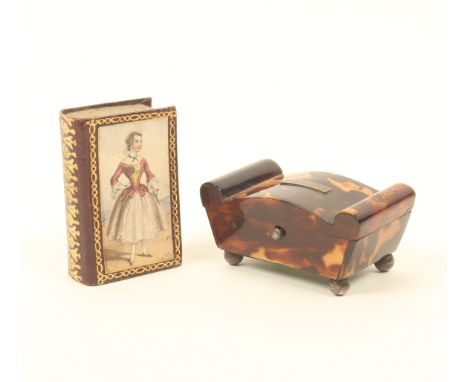 Two needle packet boxes, comprising; a tortoiseshell sarcophagus form example, with bowed lid and bolsters, white metal table