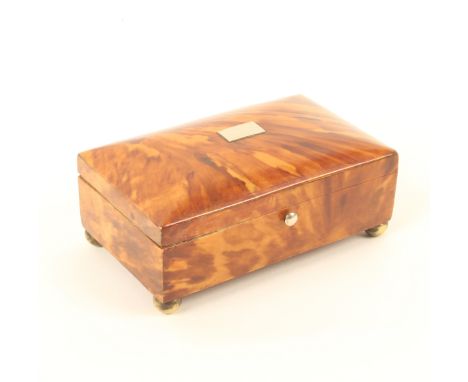 A 19th century tortoiseshell needlepacket or trinket box, the cushion lid with white metal tablet, the interior in marbled pa