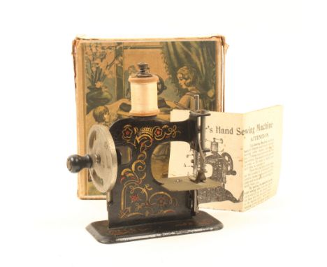 An early 20th century sewing machine for a child, 'Mullers Hand Sewing Machine', in original cardboard box with colour print 