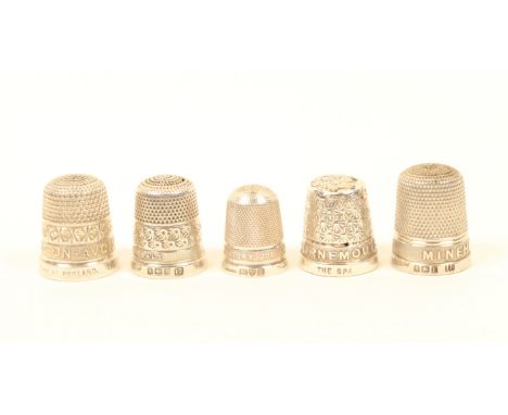 Five silver thimbles with raised letter borders, comprising; Stratford upon Avon, Minehead, Bournemouth (top repaired), Andre