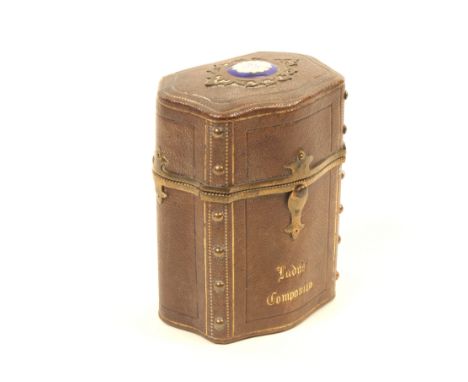 A late Victorian brown leather and brass mounted 'Lady's Companion', titled to the front, of serpentine outline, the lid with