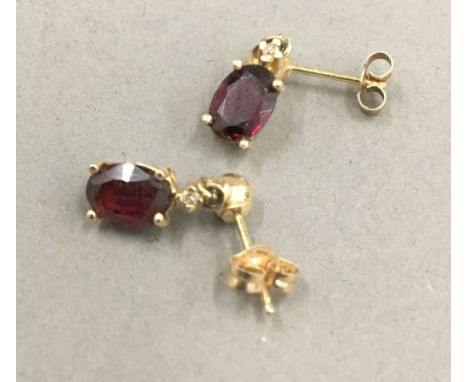 A pair of 14 ct gold diamond and ruby set drop earrings (1 gramme total weight) 