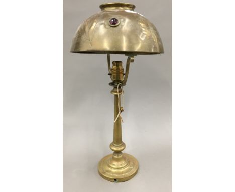 An Art Nouveau brass table lamp and a hinged brass wall light