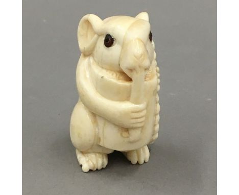 A bone netsuke formed as a mouse
