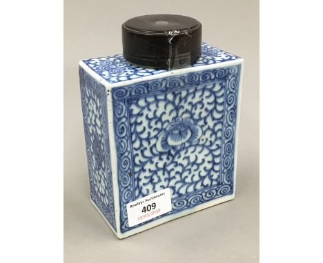 A 19th century Chinese porcelain rectangular tea caddy painted with swirling design, wooden lid