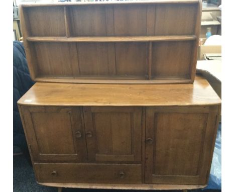 A blonde Ercol dining table, chairs and a sideboard