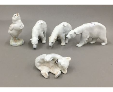 Four Royal Copenhagen porcelain polar bear figures and a bird figure