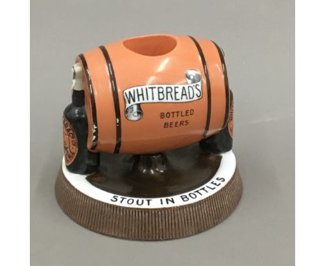 A vintage Whitbread's advertising porcelain match striker