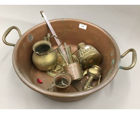 A large copper preserving pan, a ladle and assorted copper and brass items