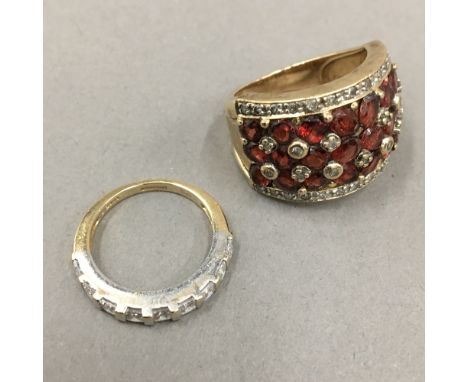 A 10 K gold redstone and diamond ring (9.4 grammes) and a 14 K gold half eternity ring (2.4 grammes)