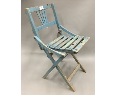 A vintage blue painted child's folding chair
