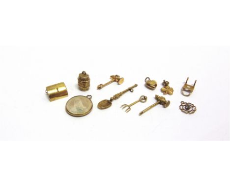 A GROUP OF TWELVE EARLY 20TH CENTURY AND LATER GOLDAND OTHER METAL CHARMS OR PENDANTS  comprising; a hammer, 23mm long (1 in)
