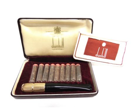 A DUNHILL 'WHITE-SPOT' 9CT GOLD MOUNTED CIGARETTE OR SMALL CIGAR HOLDER the gold cylindrical engine-turned holder with a twis