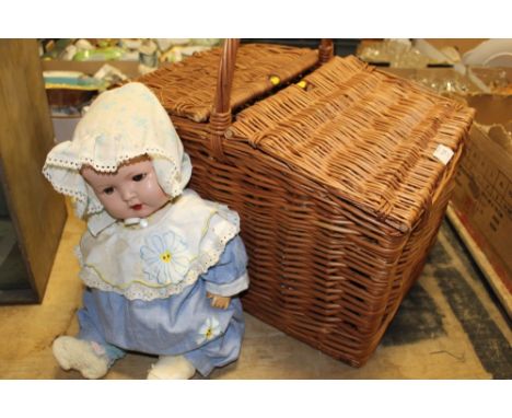 A WICKER HAMPER BASKET CONTAINING VINTAGE EVENING WARE AND A VINTAGE ROLLER EYE DOLL MARKED 037-3 1/2