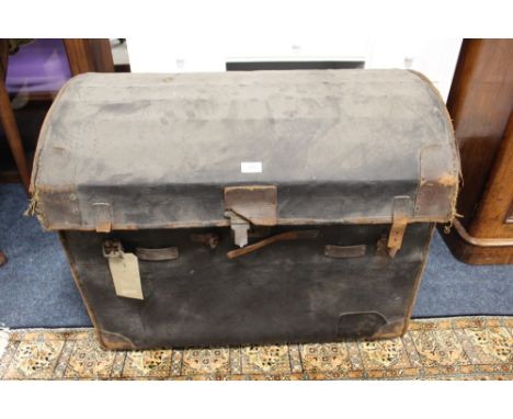 A LARGE VINTAGE DOMED TRAVELLING TRUNK, with leather carry handles, with original paper tag 'T.A.W. Giffard, 16 Alexander Squ