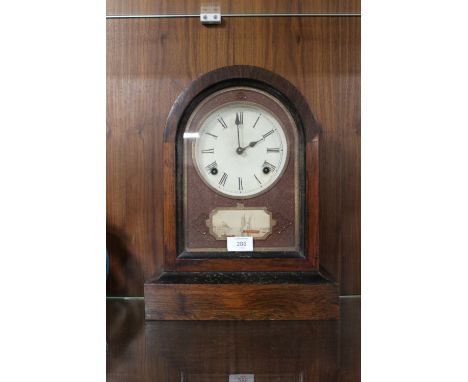 A NINETEENTH CENTURY ROSEWOOD AMERICAN MANTEL CLOCK, the domed case opening from the front, key and pendulum, H 38 cm