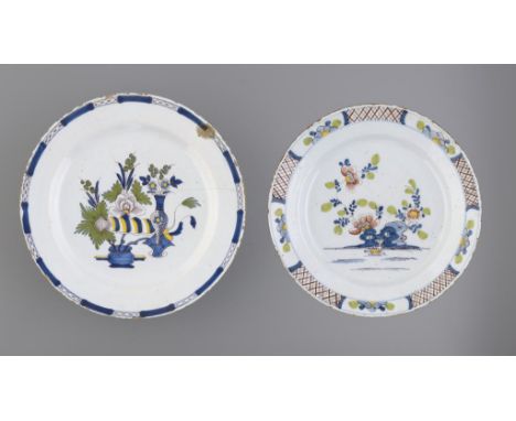 TWO ENGLISH DELFTWARE DISHES, C1760  painted with flowers and hollow rocks or flowers and auspicious objects in panelled diap