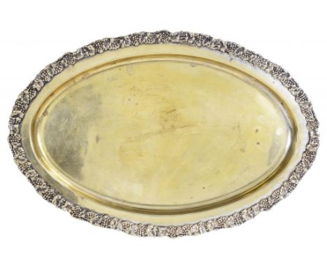 AN INDIAN SILVER GILT DISH WITH GRAPEVINE BORDER AND AN INDIAN SILVER DISH WITH REPOUSSE BORDER, BOTH MID 20TH C 44 & 33cm w,