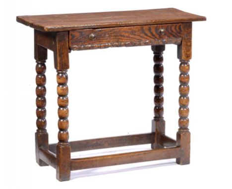 AN OAK SIDE TABLE  with two plank top and fitted with a drawer, on bobbin turned legs united by stretchers, 68cm h; 33 x 77cm