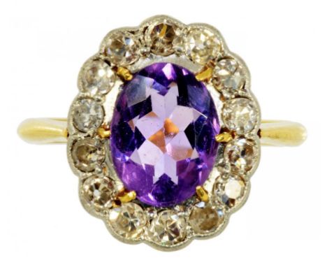 AN AMETHYST AND DIAMOND CLUSTER RING  in gold, marked 18ct & PT, 3.1g, size L ½ ++In satisfactory second hand condition