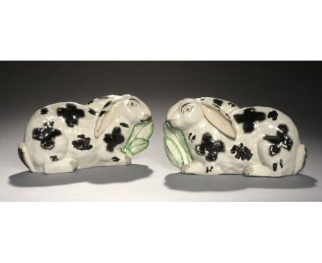 A PAIR OF STAFFORDSHIRE EARTHENWARE MODELS OF RABBITS, MID 19TH C with painted or sponged detail including feathery crosses, 