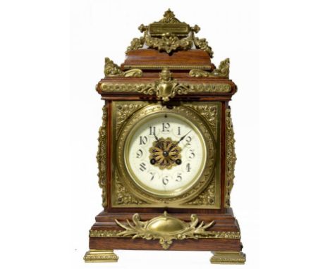 AN ORNATE FRENCH BRASS MOUNTED OAK MANTLE CLOCK, C1890 with primrose enamel dial and gong striking movement in basket topped 
