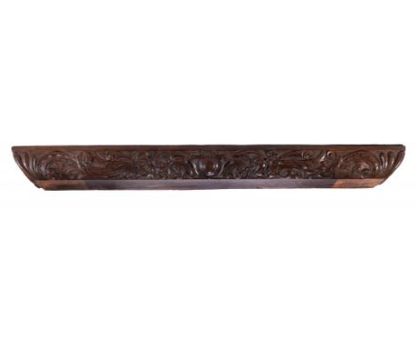 A CUSHION MOULDED AND CARVED OAK BEAM, 18TH/19TH C in 16th c style, with grotesques and scrolling foliage centred by a cartou
