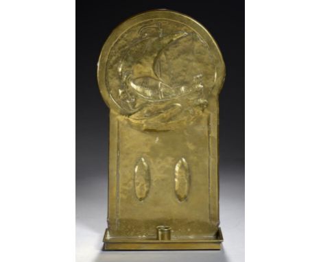 A GLASGOW SCHOOL SHEET BRASS CANDLE SCONCE, C1910 embossed with a ship, the sconce secured by three rivets, 40.5cm h ++Light 