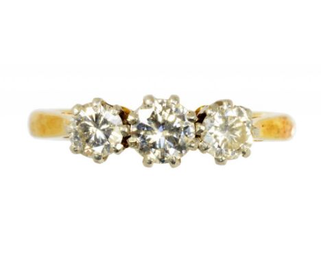 A DIAMOND THREE STONE RING with round brilliant cut diamonds,  that to the centre of approx 025ct, in gold, marked 18CT & PLA